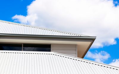 Low angle view of corrugated iron roof, copy space Closeup low angle view of corrugated iron roof of brand new house against blue sky with clouds, full frame horizontal composition with copy space